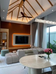 a living room with a couch and a table at Vela Villa Aonang in Ban Chong Phli
