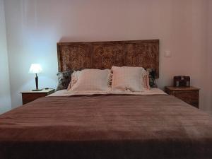 a bedroom with a large bed with two pillows at Beach & Pool in Costa da Caparica