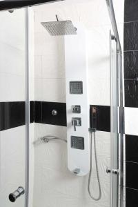 a shower with a glass door in a bathroom at Hilltop Chalet 4 in Hanioti