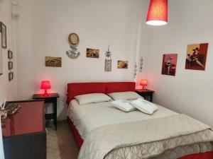 a bedroom with a bed with two lamps on two tables at Appartamenti Baia Azzurra in Leuca