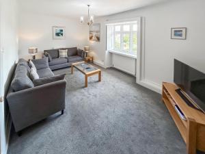 a living room with a couch and a tv at Church View in Hunstanton