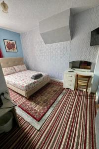 a bedroom with a bed and a desk in it at blackpool central lodge And Rooms in Blackpool