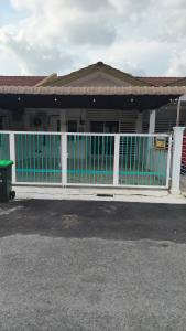 a white fence in front of a house at MatiinJannah Homestay Arau in Arau