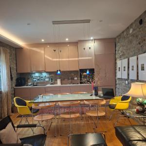 a kitchen with a table and chairs in a room at 7 Roots - Leskovik in Leskovik