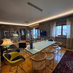 a living room with a table and chairs at 7 Roots - Leskovik in Leskovik