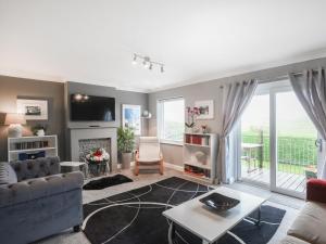 a living room with a couch and a fireplace at Mill Cottage in Aberdyfi