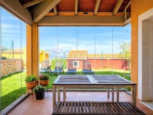 a patio with a table and a view of a yard at Casa Relax in Polop - Jacuzzi and Pool in Polop