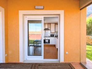 a kitchen with an open door to a dining room at Casa Relax in Polop - Jacuzzi and Pool in Polop +36 photos