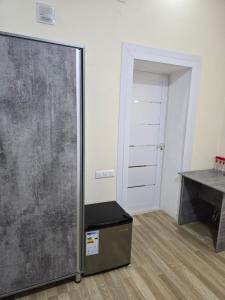 a sliding glass door in a room with a desk at ZAAL Hotel in Samarkand