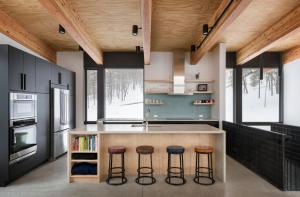 a kitchen with a island with bar stools at Sterling Treehouse in Stowe Fork