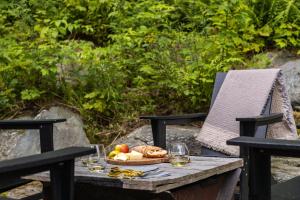 a table with a plate of food and glasses of wine at Sterling Treehouse in Stowe Fork