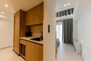 a kitchen with wooden cabinets and a counter top at Aetheria South in Kourouta