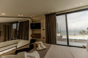 a hotel room with a bed and a large window at Aetheria South in Kourouta