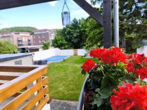 a balcony with red flowers and a bench at Ferienhaus Isabel in Gernrode - Harz +62 photos