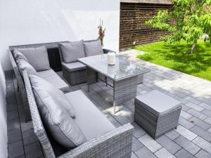 a patio with a couch and a table at Ferienhaus Isabel in Gernrode - Harz