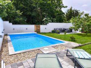 a swimming pool in the backyard of a house at Ferienhaus Isabel in Gernrode - Harz