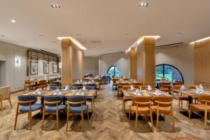 a dining room with wooden tables and chairs at Limak Arcadia Sport Resort Belek in Belek