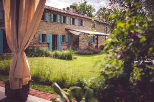 an outside view of a house with green shutters at PranaVita, B&B Naturale in Pesaro
