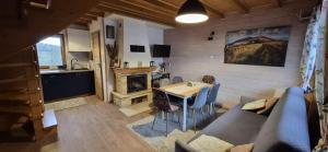 a living room with a couch and a table at Domki Obertyny in Wetlina
