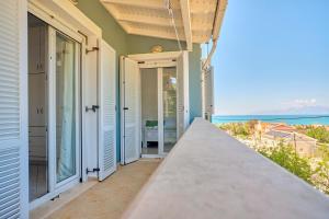 a balcony with a view of the ocean at Casa Di Kontini in Acharavi