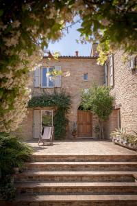 a house with a chair in front of it at Castello di Granarola Relais - Adults Friendly - in Gradara