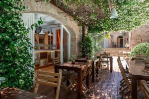an outdoor patio with tables and chairs in a building at Castello di Granarola Relais - Adults Friendly - in Gradara