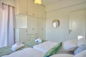 a bedroom with two beds with towels on them at Casa Di Kontini in Acharavi
