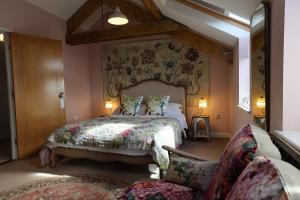 a bedroom with a large bed with a floral bedspread at Harbour View Penthouse in Lowestoft
