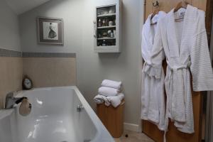 a bathroom with a white bath tub and towels at Harbour View Penthouse in Lowestoft +31 photos