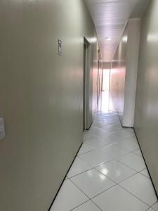 a hallway with a door and a tile floor at Pousada Medeiros in Cedro