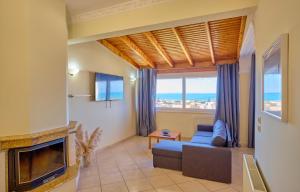 a living room with a couch and a fireplace at Casa Di Kontini in Acharavi