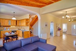 a living room and kitchen with a couch and a table at Casa Di Kontini in Acharavi +21 photos