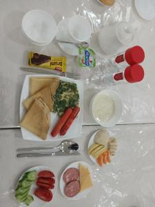 a white table with plates of food on it at ZAAL Hotel in Samarkand