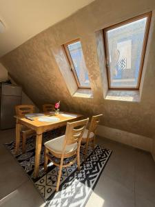 a dining room with a table and some windows at ValMar Guest rooms in Haskovo
