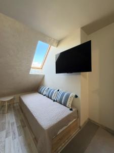 a bedroom with a bed with a flat screen tv at ValMar Guest rooms in Haskovo