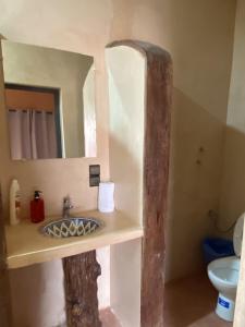 a bathroom with a sink and a mirror at Palais Ksar Lamane in Aït Benhaddou +41 photos
