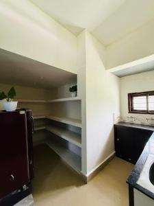 an empty room with a sink and a shelf at Jimmy nivas in Kottayam +4 photos