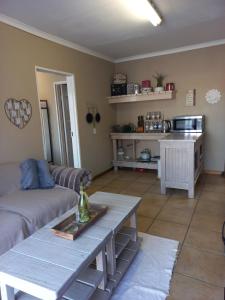 a living room with a couch and a table at Forever Clarens in Clarens