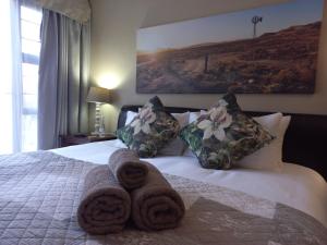 a bedroom with a bed with towels on it at Forever Clarens in Clarens