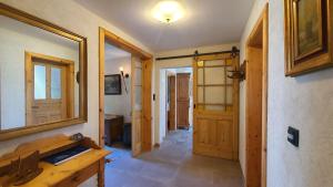 a room with a hallway with a mirror and wooden doors at Kienberghäusle in Pfronten