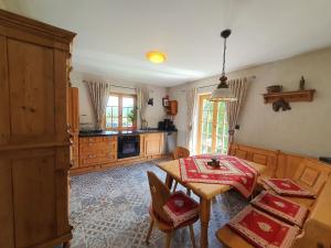 a kitchen with a table and a dining room at Kienberghäusle in Pfronten