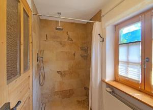 a bathroom with a shower and a window at Kienberghäusle in Pfronten +20 photos