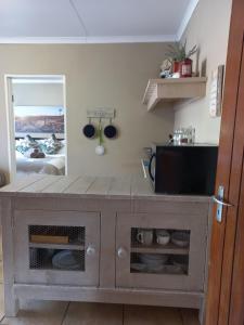 a living room with a table with a tv on it at Forever Clarens in Clarens +4 photos