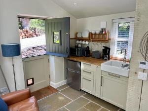 a kitchen with a sink and a counter top at The Leat at The Old Mill in Tavistock