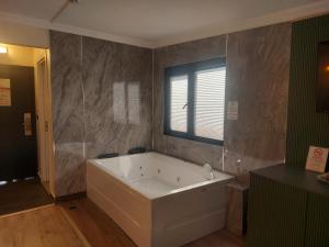 a large white bath tub in a bathroom at The Best City Kadikoy in Istanbul +16 photos