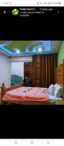 a picture of a hotel room with a bed at Cecil homes hotel in Murree