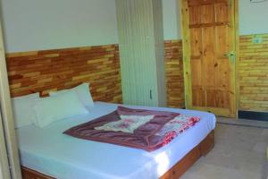 a bedroom with a large bed with a wooden headboard at Cecil homes hotel in Murree