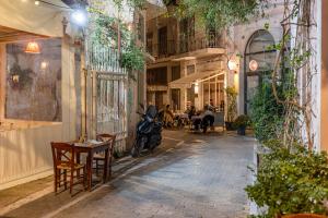 a street with a motorcycle parked in a building at Ernest Suites Psiri in Athens