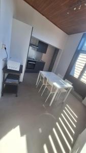a kitchen with a white table in a room at Residence La Fafa in Charleroi