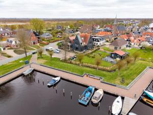 an aerial view of a town with boats in the water at Yn 'e Haven Logies in Earnewâld